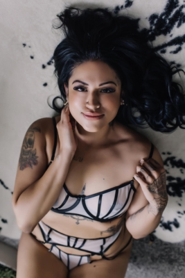 brunette woman in two piece lingerie looking at camera