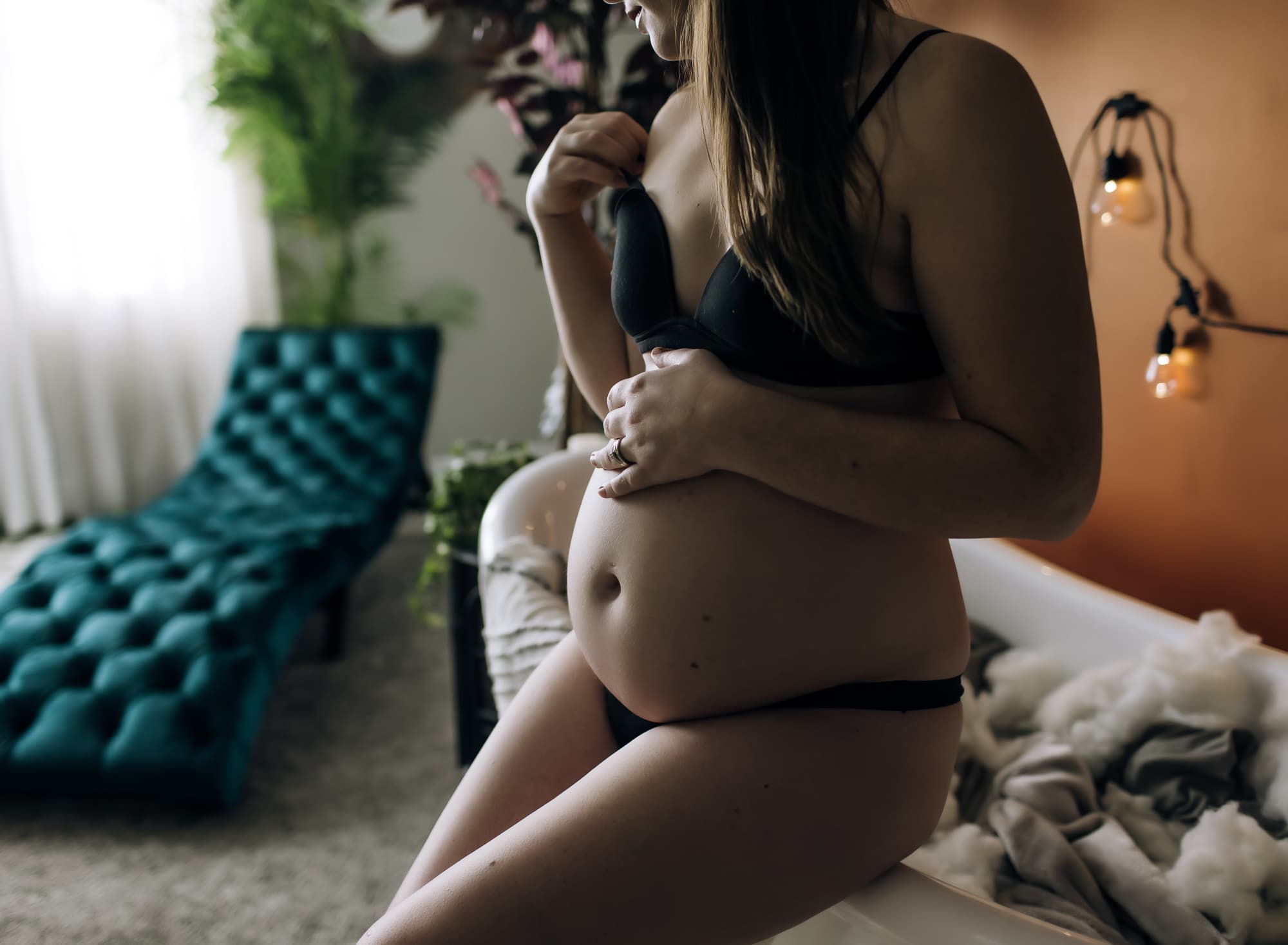 woman-in-black-bra-and-panty-pregnant-sitting-on-edge-of-tub
