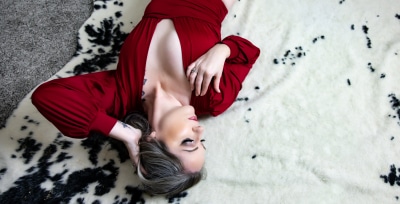 woman-in-red-bodysuit-on-cow-print-rug